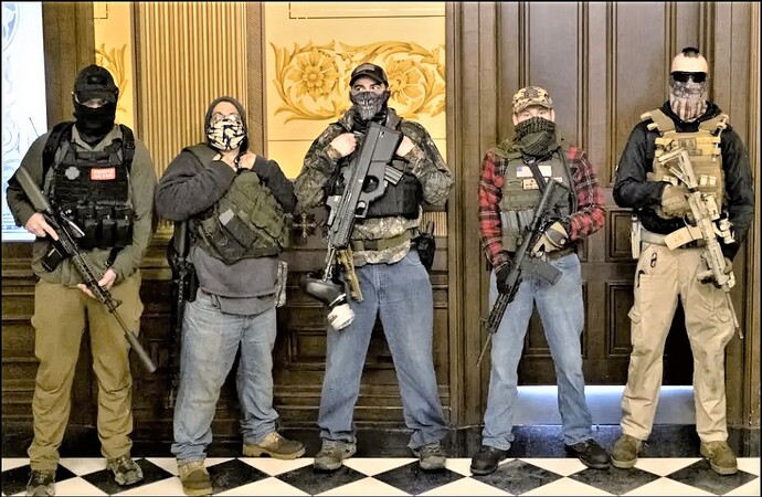 Armed-militia-group-stands-in-front-of-governors-office-to-protest-shutdowns-in-Michigan_-Photo-source-Seth-Herald_Reuters